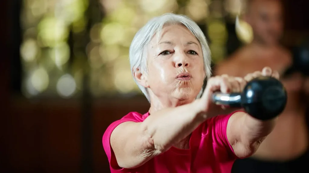 Toning Bingo Wings: Effective Exercises and Tips for Achieving Sleeker Arms 2 Person performing arm exercises with dumbbells Bognor Regis