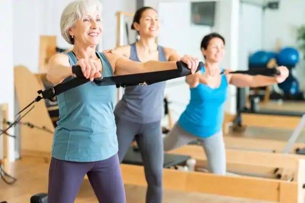 older woman doing weight training Bognor Regis and resistance in the gym to tone upper arms